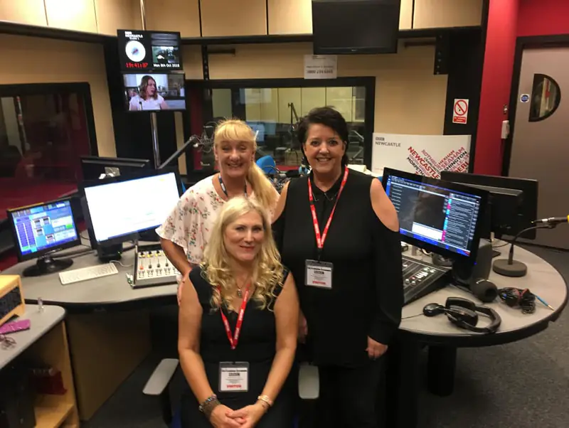 Sonya Hudson with colleagues in a radio studio