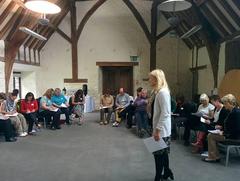 Sonya Hudson leading a group training session in a converted barn in Devon