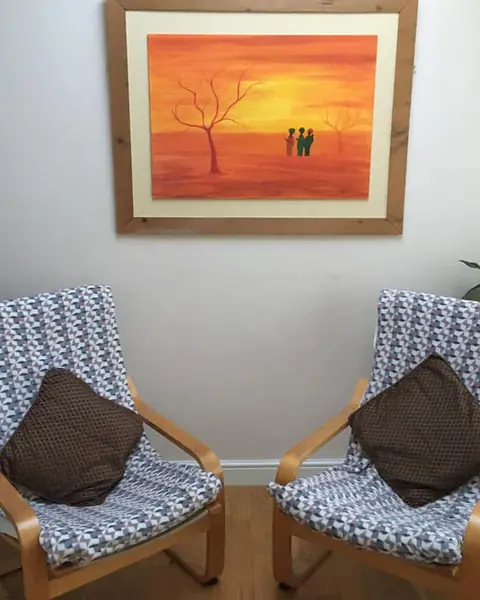 The therapy room in Wallsend with two cushioned armchairs